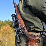 Hunter with shotgun and scope in the Ardennes, Belgium