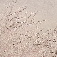 Abstract sand patterns created by retreating water on the beach at low tide, Scotland