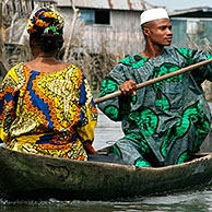 Man and woman in canoe at Ganvie, the lake village, Benin, Africa