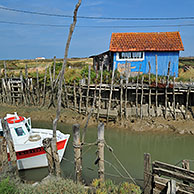 Colourful cabins of oyster farm at la Baudissière near Dolus / Saint-Pierre-d'Oléron on the island Ile d'Oléron, Charente-Maritime, France