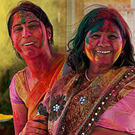 Women covered in colourful dye celebrating the Holi festival, Festival of Colours in Mathura, Uttar Pradesh, India