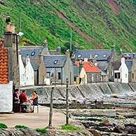Crovie, a small village on a narrow ledge along the sea comprising a single row of houses in Aberdeenshire, Scotland, UK
